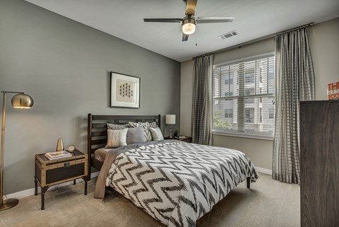 a bedroom with a bed and a ceiling fan